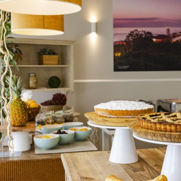 Delicious cakes on stands in a cozy breakfast room with a warm atmosphere.